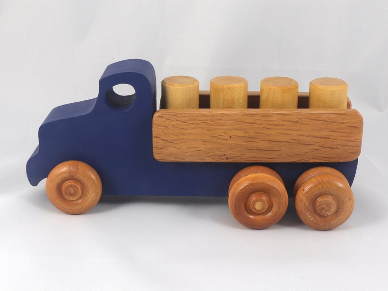This handmade wooden Lorry truck is finished with navy blue acrylic paint and Amber Shellac. It is one of five towable trucks in this collection, available in many colors and unfinished. Custom Orders are welcome.