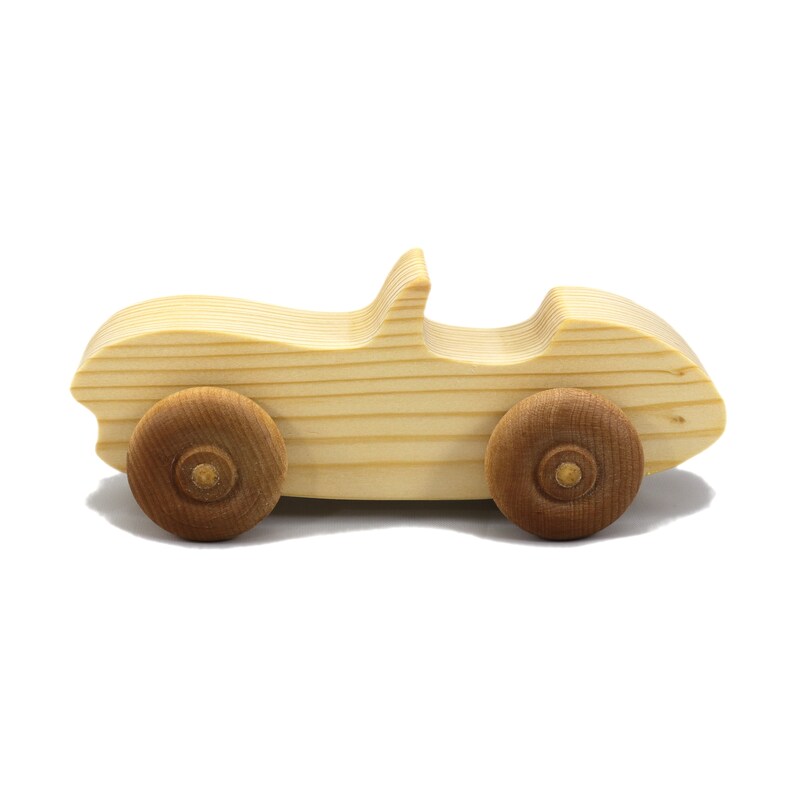 A small, handcrafted wooden toy convertible sports car, finished with a custom blend of oils and waxes, is the perfect gift for young children.