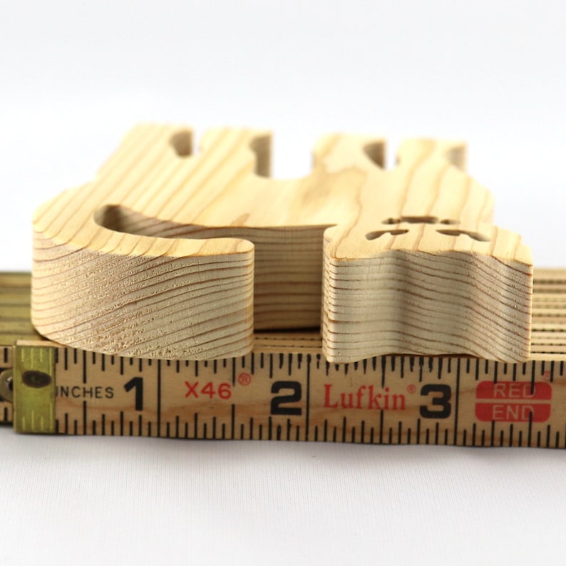 Handmade unfinished wooden Halloween cat cutout by Odin's Toy Factory. Freestanding cat figure cut from 3/4 inch thick wood and ready to paint. Approximate size 3.5 inches height by 3.5 inches width by 0.75 inches thick. Hand-cut solid wood Halloween decoration for crafts, toys, ornaments, and display. Custom orders available. Made in Tallahassee, Florida, USA.