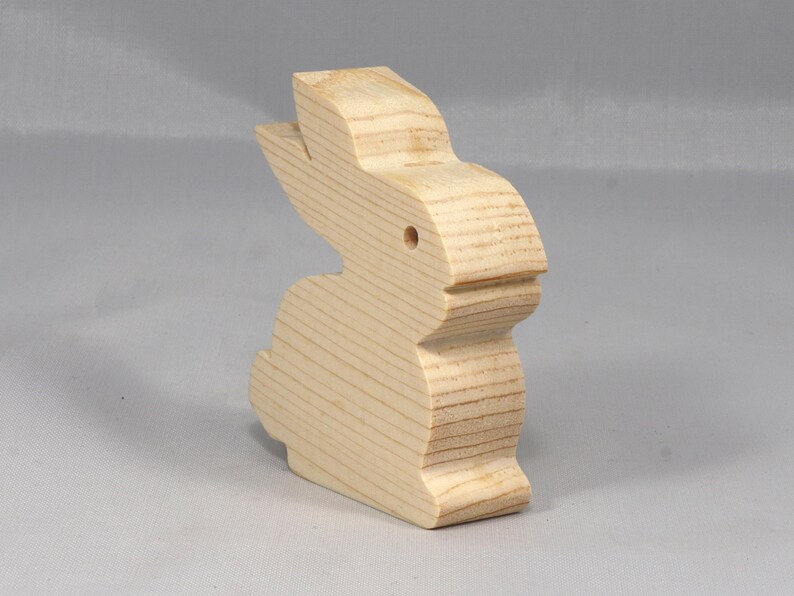 This is an unfinished wooden Rabbit cutout from solid wood using traditional woodworking techniques. Sanded smooth and ready to paint, stain, or customize. Freestanding design for small hands, toddlers, young children, crafters, collectors, and display. I take custom orders for any animal, quantity, and mix — including large ornament orders. Mix and match, request a different size, or send a drawing or pattern. Handmade by Odin's Toy Factory in Tallahassee, Florida, USA.