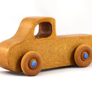 This handmade toy pickup truck from My Play Pal Collection is finished with amber shellac and metallic sapphire blue acrylic paint. It is just one of many unique wooden vehicles available.