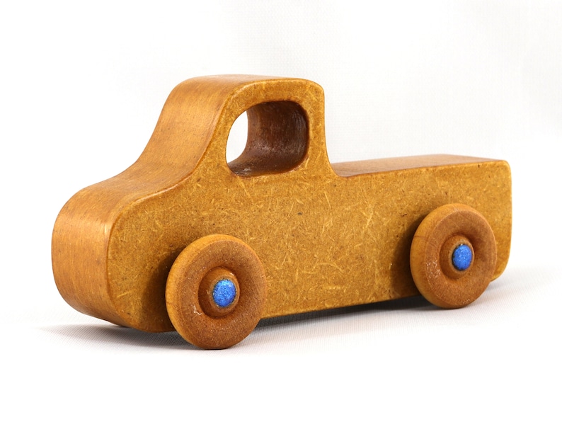 This handmade toy pickup truck from My Play Pal Collection is finished with amber shellac and metallic sapphire blue acrylic paint. It is just one of many unique wooden vehicles available.