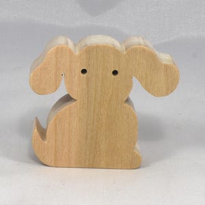 This is an unfinished wooden Puppy Dog cutout from solid wood using traditional woodworking techniques. Sanded smooth and ready to paint, stain, or customize. Freestanding design for small hands, toddlers, young children, crafters, collectors, and display. I take custom orders for any animal, quantity, and mix — including large ornament orders. Mix and match, request a different size, or send a drawing or pattern. Handmade by Odin's Toy Factory in Tallahassee, Florida, USA.