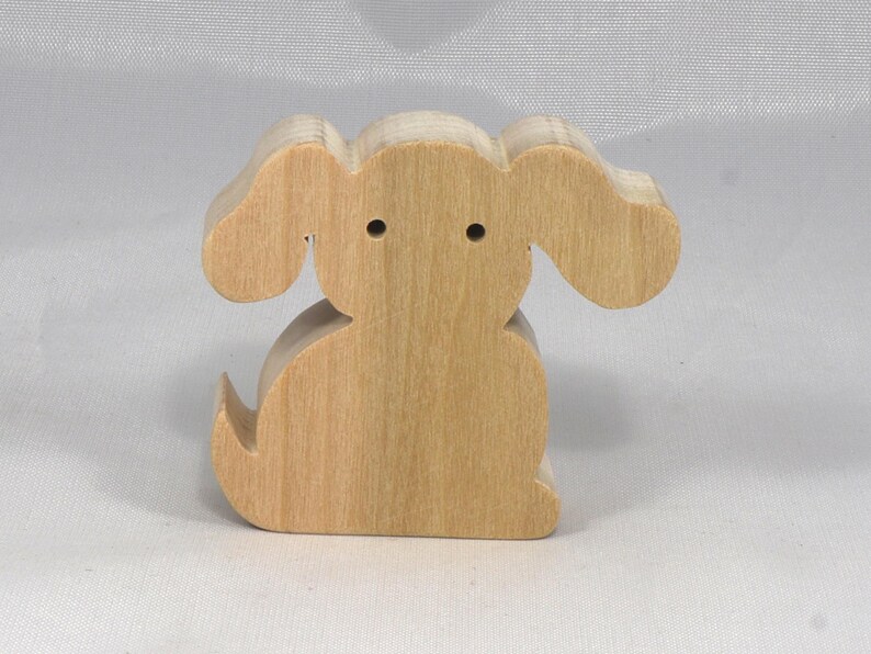 This is an unfinished wooden Puppy Dog cutout from solid wood using traditional woodworking techniques. Sanded smooth and ready to paint, stain, or customize. Freestanding design for small hands, toddlers, young children, crafters, collectors, and display. I take custom orders for any animal, quantity, and mix — including large ornament orders. Mix and match, request a different size, or send a drawing or pattern. Handmade by Odin's Toy Factory in Tallahassee, Florida, USA.