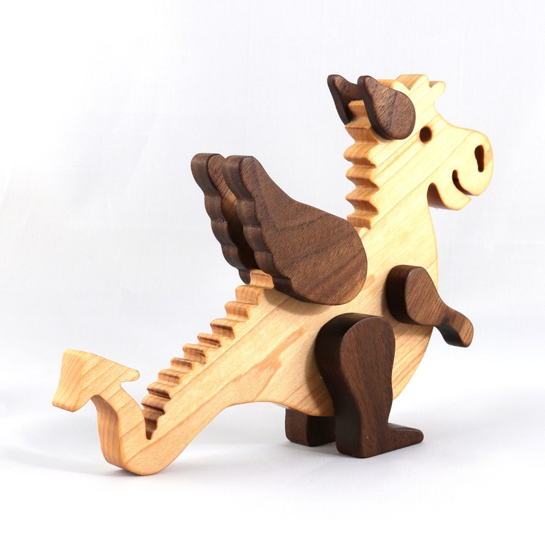 Handmade wood baby dragon fantasy animal figurine made from select grade contrasting hardwoods and hand finished with a durable custom blend of mineral oil and waxes.