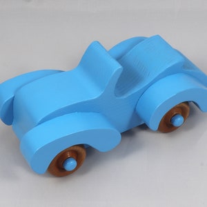 Handmade painted wooden toy car, baby blue convertible with fat fendered roadster design. Non-marring wheels finished with amber shellac.