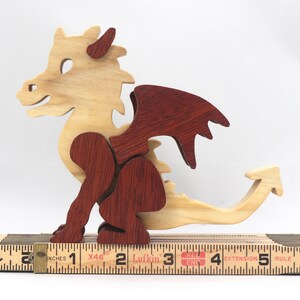 Hand-crafted baby dragon mythical fantasy animal figurine made from contrasting high-quality hardwoods and finished with non-toxic oils and waxes. Perfect for any dragon enthusiast.