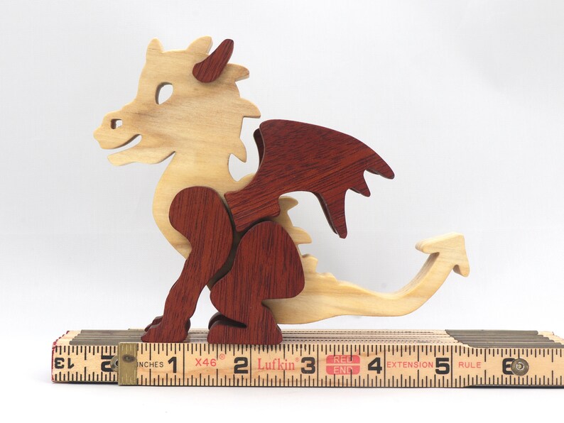 Hand-crafted baby dragon mythical fantasy animal figurine made from contrasting high-quality hardwoods and finished with non-toxic oils and waxes. Perfect for any dragon enthusiast.