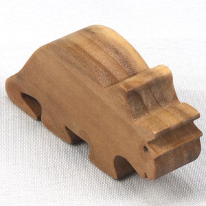This small wooden triceratops dinosaur toy is crafted from high-quality hardwood and hand-finished. It is a delightful plaything for young children and appeals to many adults.