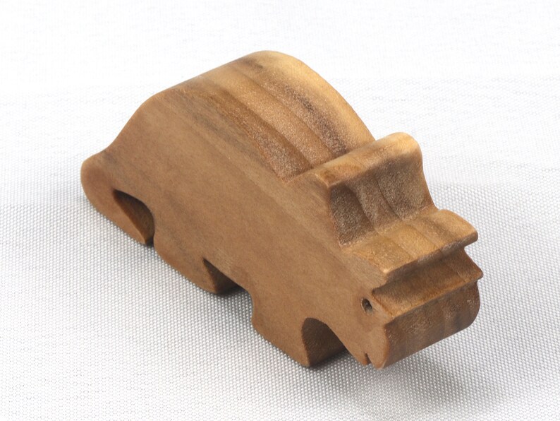 This small wooden triceratops dinosaur toy is crafted from high-quality hardwood and hand-finished. It is a delightful plaything for young children and appeals to many adults.