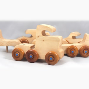 Handmade wooden toy truck play set includes three cars and a tractor-trailer finished with clear and amber shellac with metallic sapphire blue trim.