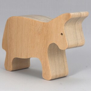 A handmade and unfinished wooden toy cow cutout is perfect for those who love to paint and customize their toys. It is freestanding and stackable, making it a versatile addition to any playroom or nursery. From My Itty Bitty Animal Collection.