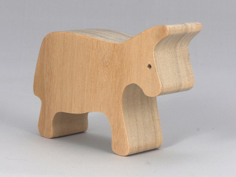 A handmade and unfinished wooden toy cow cutout is perfect for those who love to paint and customize their toys. It is freestanding and stackable, making it a versatile addition to any playroom or nursery. From My Itty Bitty Animal Collection.