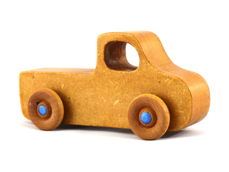 This handmade toy pickup truck from My Play Pal Collection is finished with amber shellac and metallic sapphire blue acrylic paint. It is just one of many unique wooden vehicles available.