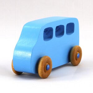 A Handmade wood toy mini van hand-painted baby blue with metallic sapphire blue trim and wheels finished with nonmarring amber shellac from my Play Pall Collection.