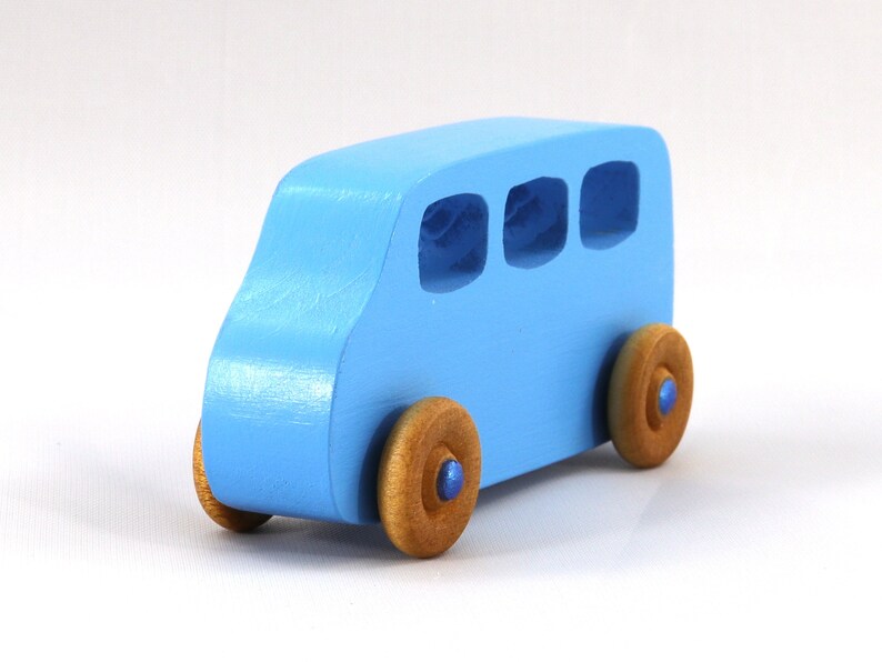 A Handmade wood toy mini van hand-painted baby blue with metallic sapphire blue trim and wheels finished with nonmarring amber shellac from my Play Pall Collection.