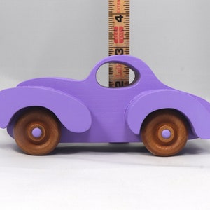A Handmade Wood Toy Car Fat Fendered Coupe Hand Painted With Amethyst Acrylic Paint And Amber Shellac