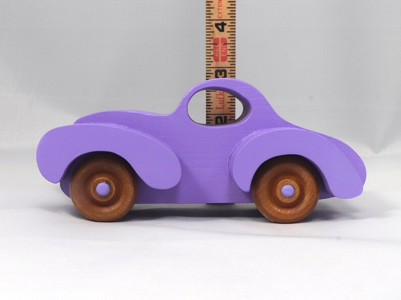 A Handmade Wood Toy Car Fat Fendered Coupe Hand Painted With Amethyst Acrylic Paint And Amber Shellac
