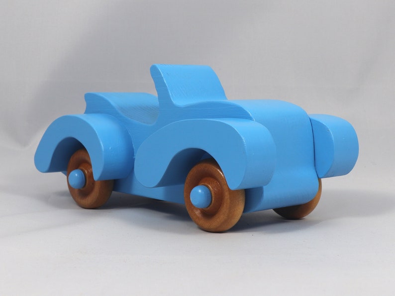 Handmade painted wooden toy car, baby blue convertible with fat fendered roadster design. Non-marring wheels finished with amber shellac.
