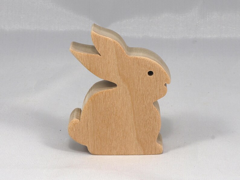 This is an unfinished wooden Rabbit cutout from solid wood using traditional woodworking techniques. Sanded smooth and ready to paint, stain, or customize. Freestanding design for small hands, toddlers, young children, crafters, collectors, and display. I take custom orders for any animal, quantity, and mix — including large ornament orders. Mix and match, request a different size, or send a drawing or pattern. Handmade by Odin's Toy Factory in Tallahassee, Florida, USA.