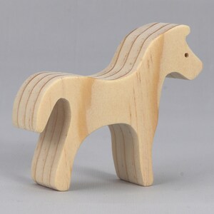 Handmade wooden toy horse cutout, perfect for children's playtime collection. Freestanding and stackable, ready to paint or customize. Endless possibilities for imaginative play, from farm scenes to towering animal creations.