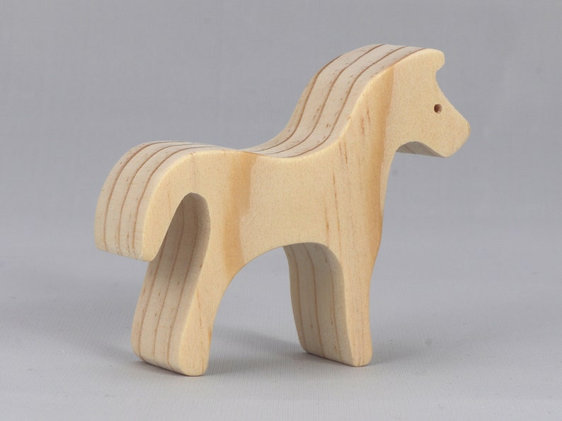 Handmade wooden toy horse cutout, perfect for children's playtime collection. Freestanding and stackable, ready to paint or customize. Endless possibilities for imaginative play, from farm scenes to towering animal creations.