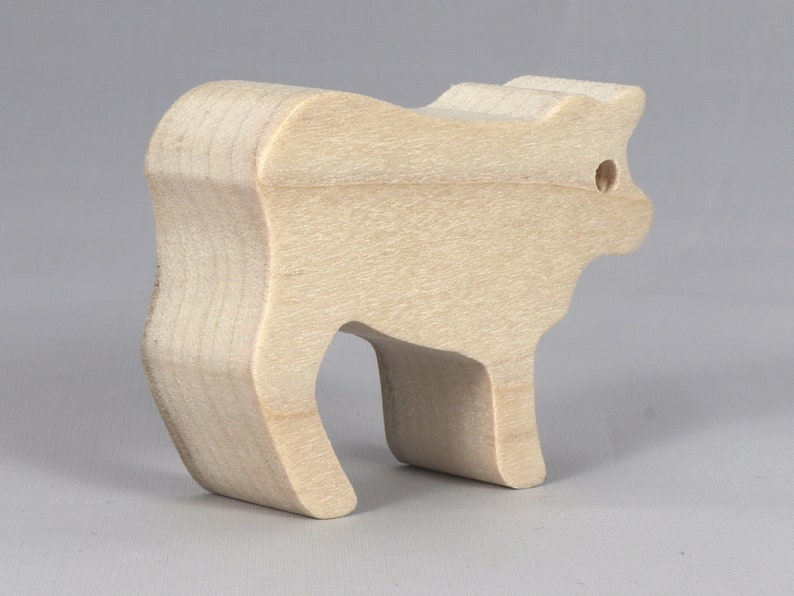 Handmade unfinished wooden toy baby calf cutout, unpainted and ready to paint, freestanding farm animal figure from Odin's Toy Factory’s  Itty Bitty Animal Collection. Handcrafted in Tallahassee, Florida, USA, using reclaimed natural wood offcuts. Perfect for imaginative play, stacking, collectors, and crafting.