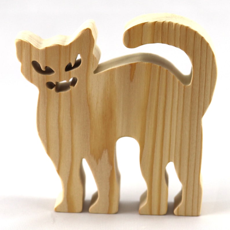 Handmade unfinished wooden Halloween cat cutout by Odin's Toy Factory. Freestanding cat figure cut from 3/4 inch thick wood and ready to paint. Approximate size 3.5 inches height by 3.5 inches width by 0.75 inches thick. Hand-cut solid wood Halloween decoration for crafts, toys, ornaments, and display. Custom orders available. Made in Tallahassee, Florida, USA.