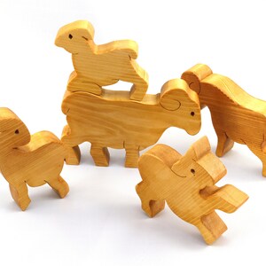 Handmade wooden toy stacking puzzle with five freestanding goats finished with a custom blend of nontoxic oils and waxes.
