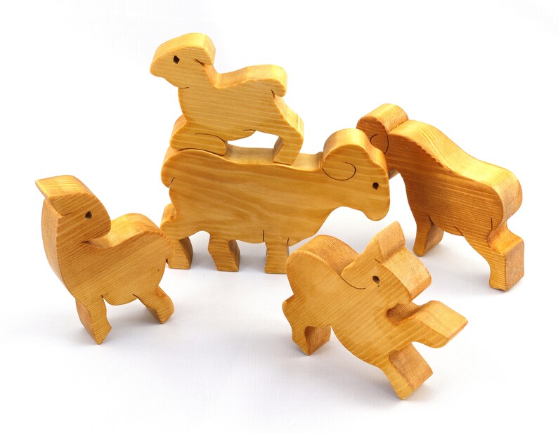 Handmade wooden toy stacking puzzle with five freestanding goats finished with a custom blend of nontoxic oils and waxes.