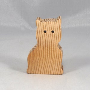 A handmade freestanding wooden toy cat cutout 1/2-3/4 inches thick is made from various kinds of wood sanded smooth and ready to paint. It is excellent for kids' crafts, pretend, or stacking toys. Other sizes are available with a custom order.