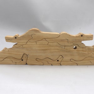 Handmade Wood Alligator Family Stacking Puzzle Mom and five baby (hatchling) alligators. This freestanding puzzle is hand-finished with a custom blend of mineral oil and waxes for a beautiful, smooth, and durable finish.