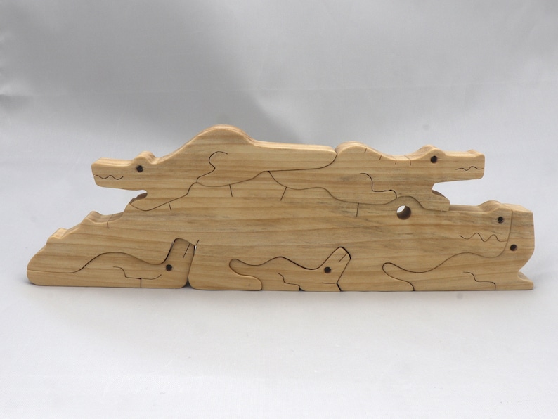 Handmade Wood Alligator Family Stacking Puzzle Mom and five baby (hatchling) alligators. This freestanding puzzle is hand-finished with a custom blend of mineral oil and waxes for a beautiful, smooth, and durable finish.