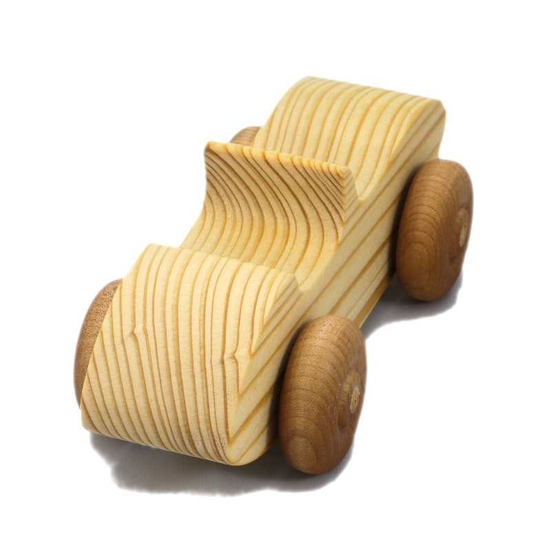 A small, handcrafted wooden toy convertible sports car, finished with a custom blend of oils and waxes, is the perfect gift for young children.