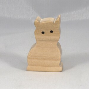 A handmade freestanding wooden toy cat cutout 1/2-3/4 inches thick is made from various kinds of wood sanded smooth and ready to paint. It is excellent for kids' crafts, pretend, or stacking toys. Other sizes are available with a custom order.