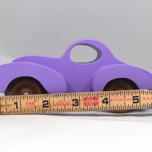 A Handmade Wood Toy Car Fat Fendered Coupe Hand Painted With Amethyst Acrylic Paint And Amber Shellac