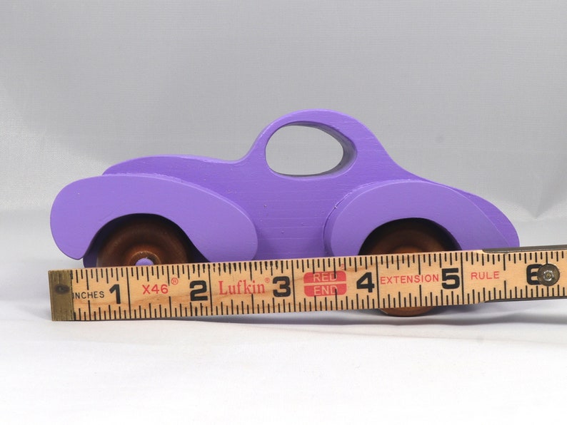 A Handmade Wood Toy Car Fat Fendered Coupe Hand Painted With Amethyst Acrylic Paint And Amber Shellac