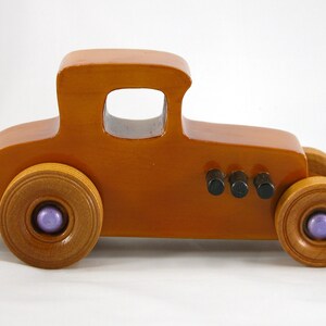 Handmade wooden toy car '27 T-Coupe, finished with amber shellac, metallic purple, and black acrylic paint. Made to order.