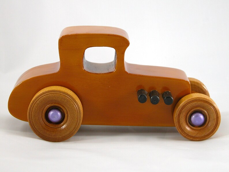 Handmade wooden toy car '27 T-Coupe, finished with amber shellac, metallic purple, and black acrylic paint. Made to order.