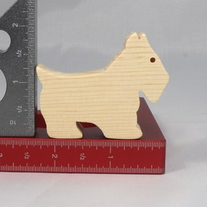 Handmade wood toy Scottie dog cutout unfinished unpainted paintable freestanding Itty Bitty Animal Collection. Approximate size 2.5 inches length by 2 inches height by 0.75 inches width. Handmade in Tallahassee Florida USA from natural wood offcuts.