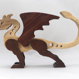 Handmade wood dragon figurine made from select grade contrasting hardwoods and hand-finished with a custom mixture of mineral oil and waxes.
