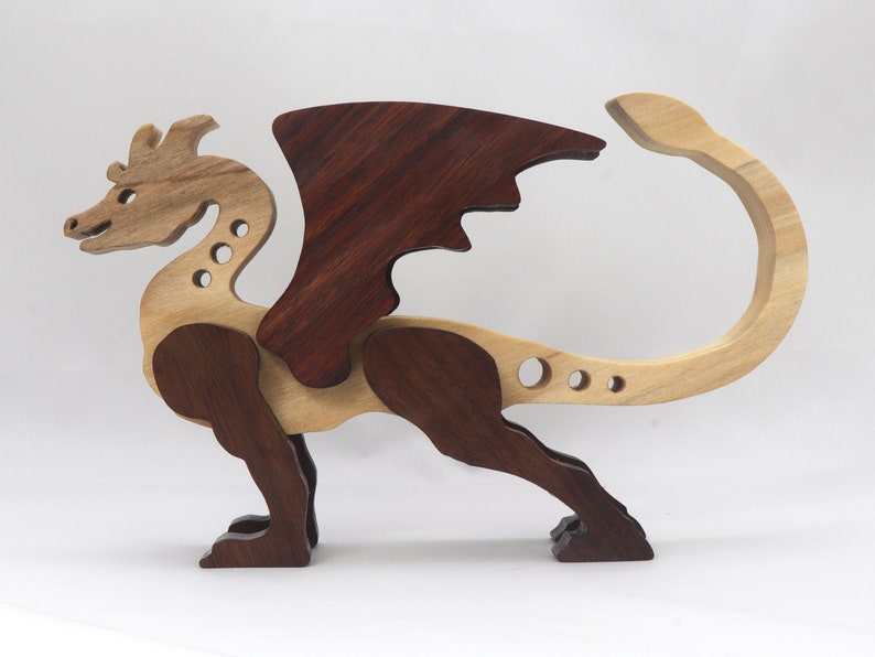 Handmade wood dragon figurine made from select grade contrasting hardwoods and hand-finished with a custom mixture of mineral oil and waxes.