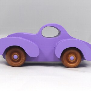 A Handmade Wood Toy Car Fat Fendered Coupe Hand Painted With Amethyst Acrylic Paint And Amber Shellac