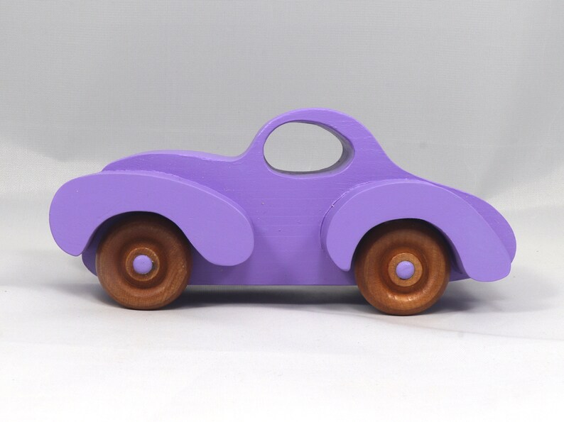 A Handmade Wood Toy Car Fat Fendered Coupe Hand Painted With Amethyst Acrylic Paint And Amber Shellac