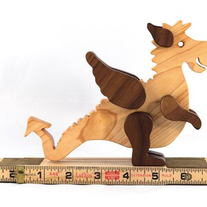 Handmade wood baby dragon fantasy animal figurine made from select grade contrasting hardwoods and hand finished with a durable custom blend of mineral oil and waxes.