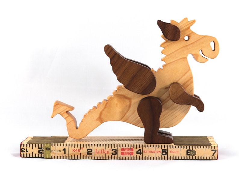 Handmade wood baby dragon fantasy animal figurine made from select grade contrasting hardwoods and hand finished with a durable custom blend of mineral oil and waxes.