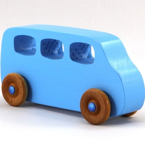 A Handmade wood toy mini van hand-painted baby blue with metallic sapphire blue trim and wheels finished with nonmarring amber shellac from my Play Pall Collection.