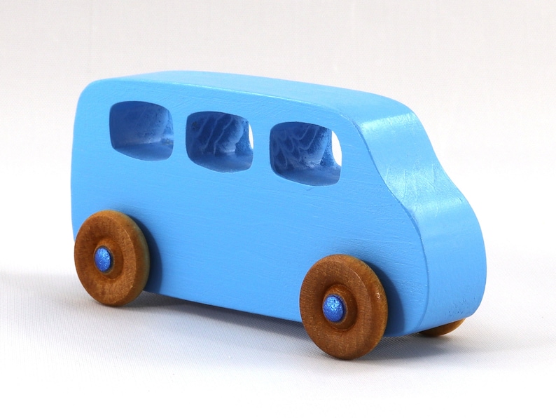 A Handmade wood toy mini van hand-painted baby blue with metallic sapphire blue trim and wheels finished with nonmarring amber shellac from my Play Pall Collection.