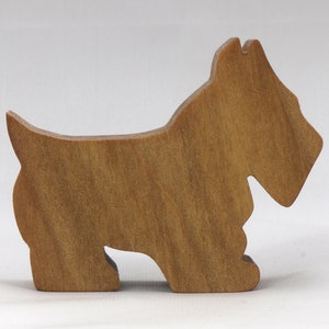 Handmade wooden Scottie dog toy cutout finished with mineral oil and beeswax blend. Freestanding stackable design from my Itty Bitty Animal Collection. Handcrafted in Tallahassee, Florida, USA from quality hardwood. Approximate size: length 2-1/2 inches, height 2 inches, width 3/4 inch. Each piece is unique with natural wood grain variations.