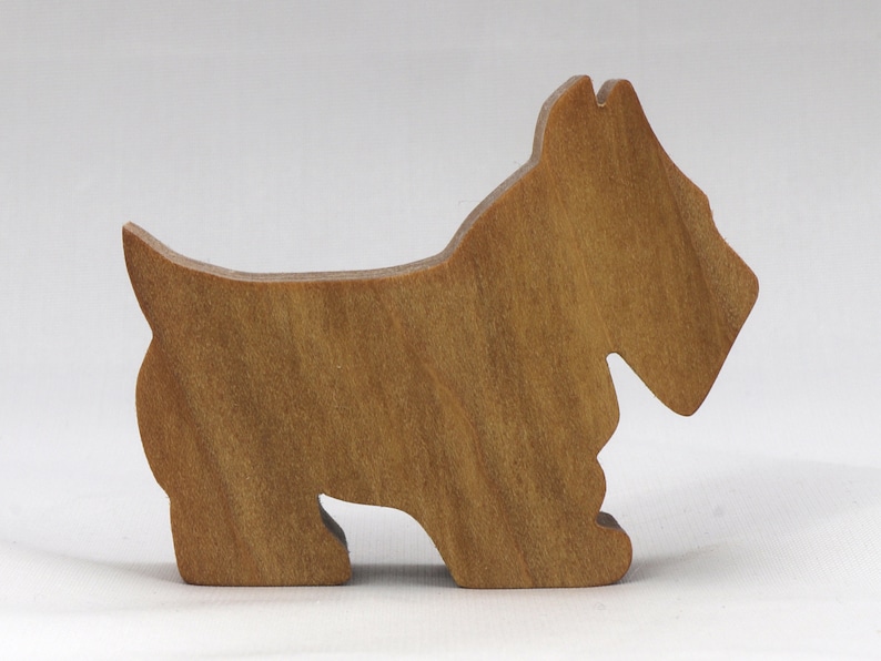 Handmade wooden Scottie dog toy cutout finished with mineral oil and beeswax blend. Freestanding stackable design from my Itty Bitty Animal Collection. Handcrafted in Tallahassee, Florida, USA from quality hardwood. Approximate size: length 2-1/2 inches, height 2 inches, width 3/4 inch. Each piece is unique with natural wood grain variations.
